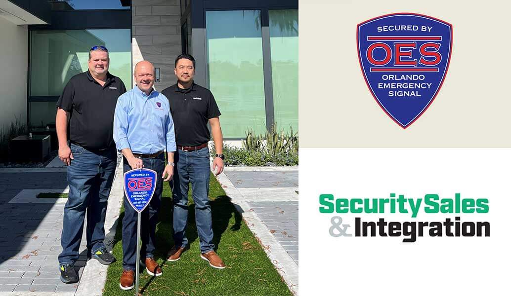 Orlando Emergency Signal installers and a home owner with the Security Sales & Integration logo on the right side of the banner.